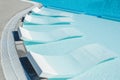 Sun beds. Sun beds in the water. Swimming pool. Relax Royalty Free Stock Photo
