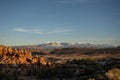 Sun Begins To Set Over The Fiery Furnace With The Snowy La Sal Mountains In The Distance