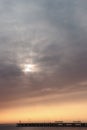 Sun behind clouds above sea horizon Royalty Free Stock Photo