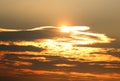 Sun behind clouds with golden linings Royalty Free Stock Photo