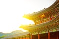 Sun behind roof top of the gate to Gyeongbokgung Palace - translation for this word is
