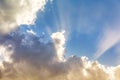 Background of colorful clouds, sun behind the clouds and sunbeams in the sky Royalty Free Stock Photo