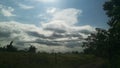 Sun behind the gray and white clouds. Gloomy weather Royalty Free Stock Photo