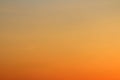 Sun below the horizon and fiery dramatic orange sky at sunset or dawn backlit by the sun. Place for text and design Royalty Free Stock Photo