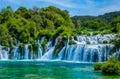 Sun breaks through to render blue water at the cascades of Krka National Park Royalty Free Stock Photo