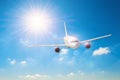 Sun with bright rays in the blue sky with white light clouds, flying airplane traveling on vacation Royalty Free Stock Photo