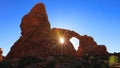 Sun burst through double arch window in Arches national park Royalty Free Stock Photo