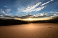 Sun Burst Warms Cool Sand Dune Royalty Free Stock Photo