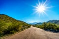 Sun casting its sun rays on the East San Juan Road near the San Juan Trail Head in the mountains of South Mountain Park