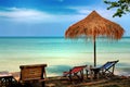 Sun chair under umbrella on a tropical sandy beach Royalty Free Stock Photo
