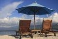 Sun chairs and umbrella on a beach Royalty Free Stock Photo