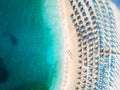 Sun chairs and umbrellas beach with no tourists and clear blue water Royalty Free Stock Photo