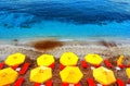 Sun chairs and umbrellas top view on multicolor red white sand sand beach in Crete, Greece Royalty Free Stock Photo