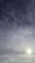 Sun, cloudy sky and vapor trail Royalty Free Stock Photo