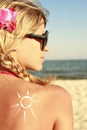 Of sun cream on the female back on the beach Royalty Free Stock Photo