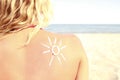 Of sun cream on the female back on the beach Royalty Free Stock Photo