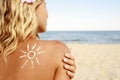 Of sun cream on the female back on the beach Royalty Free Stock Photo