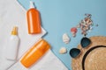 Sun cream, sun hat, cream, sunscreen bottle, sun cream, lotion bottle, seashells on a blue background. Sun protection. Beach flat Royalty Free Stock Photo