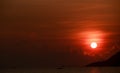 sun disk among red sky fishing boats on horizon at sunrise Royalty Free Stock Photo