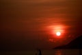 Sun disk among red sky fishing boats on horizon at sunrise Royalty Free Stock Photo