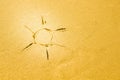 Sun drawing made on a sandy beach Royalty Free Stock Photo