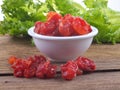 Sun-dried cocktail tomatoes on wooden background