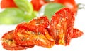 Sun-dried tomatoes with basil leaves Royalty Free Stock Photo