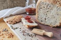 sun-dried tomatoes on a crust of fresh bread. Healthy food concept. loaf of homemade whole grain bread and a cut slice Royalty Free Stock Photo