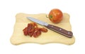 Sun dried tomatoes on cutting board with knife Royalty Free Stock Photo