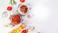 Sun dried tomatoes with fresh herbs and spices. Delicious snack on a light background, top view. Long banner format. space for Royalty Free Stock Photo