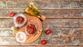 Sun dried tomatoes with fresh herbs and spices. Delicious snack on wooden textured background, top view. space for text. Long Royalty Free Stock Photo