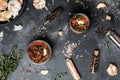 Sun dried tomatoes with fresh herbs and spices, sea salt in olive oil in a glass jar. Top view. Print for kitchen Royalty Free Stock Photo