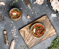 Sun dried tomatoes with fresh herbs and spices, sea salt in olive oil in a glass jar. Top view. Print for kitchen Royalty Free Stock Photo