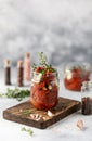 Sun dried tomatoes with fresh herbs and spices, sea salt in olive oil in a glass jar. Top view. Print for kitchen Royalty Free Stock Photo