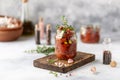 Sun dried tomatoes with fresh herbs and spices, sea salt in olive oil in a glass jar. Top view. Print for kitchen Royalty Free Stock Photo