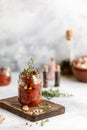 Sun dried tomatoes with fresh herbs and spices, sea salt in olive oil in a glass jar. Top view. Print for kitchen Royalty Free Stock Photo