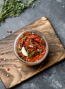 Sun dried tomatoes with fresh herbs and spices, sea salt in olive oil in a glass jar. Top view. Print for kitchen Royalty Free Stock Photo