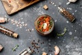 Sun dried tomatoes with fresh herbs and spices, sea salt in olive oil in a glass jar. Top view. Print for kitchen Royalty Free Stock Photo