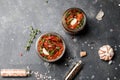 Sun dried tomatoes with fresh herbs and spices, sea salt in olive oil in a glass jar. Top view. Print for kitchen Royalty Free Stock Photo