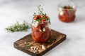 Sun dried tomatoes with fresh herbs and spices, sea salt in olive oil in a glass jar. Top view. Print for kitchen Royalty Free Stock Photo