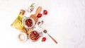 Sun dried tomatoes with fresh herbs and spices in spoon on a light table. top view. Long banner format. space for text Royalty Free Stock Photo