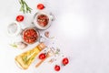 Sun dried tomatoes with garlic, oregano, olive oil in a jar on a light table, banner, menu recipe place for text, top view Royalty Free Stock Photo