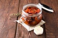 Sun dried tomatoes with herbs and sea salt in olive oil in a glass jar Royalty Free Stock Photo