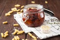 Sun dried tomatoes with herbs and sea salt in olive oil in a glass jar Royalty Free Stock Photo