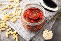 Sun dried tomatoes with herbs and sea salt in olive oil in a glass jar Royalty Free Stock Photo