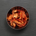 Sun dried tomatoes slices with Italian herbs and spices on dark. Homemade dehydrated vegetable Royalty Free Stock Photo