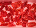 Sun dried tomatoes with spices on a pink oven dish