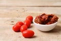 Sun dried tomatoes on wooden background table top view.