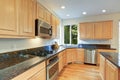 Sun filled gourmet kitchen with wooden cabinetry