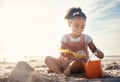 Sun flare, beach and happy girl with sand, toys and vacation with happiness, playing and cheerful. Kid, shore and female Royalty Free Stock Photo